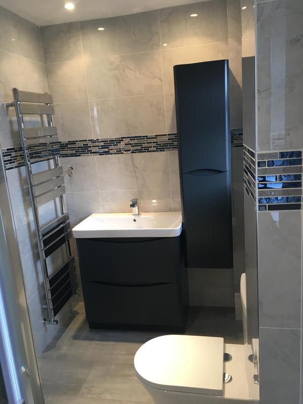 Marble-finish bathroom refit with graphite vanity and chrome heated towel rail