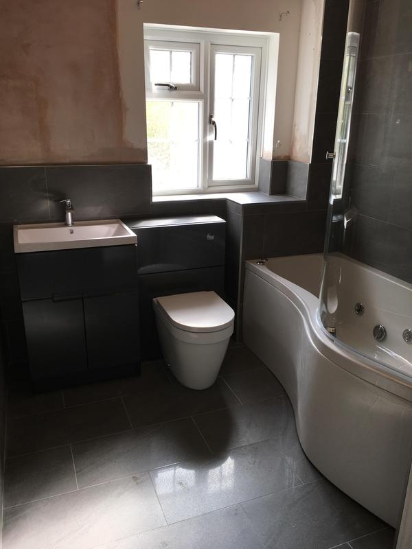 Bathroom mid-renovation with stripped walls before retiling and fit-out