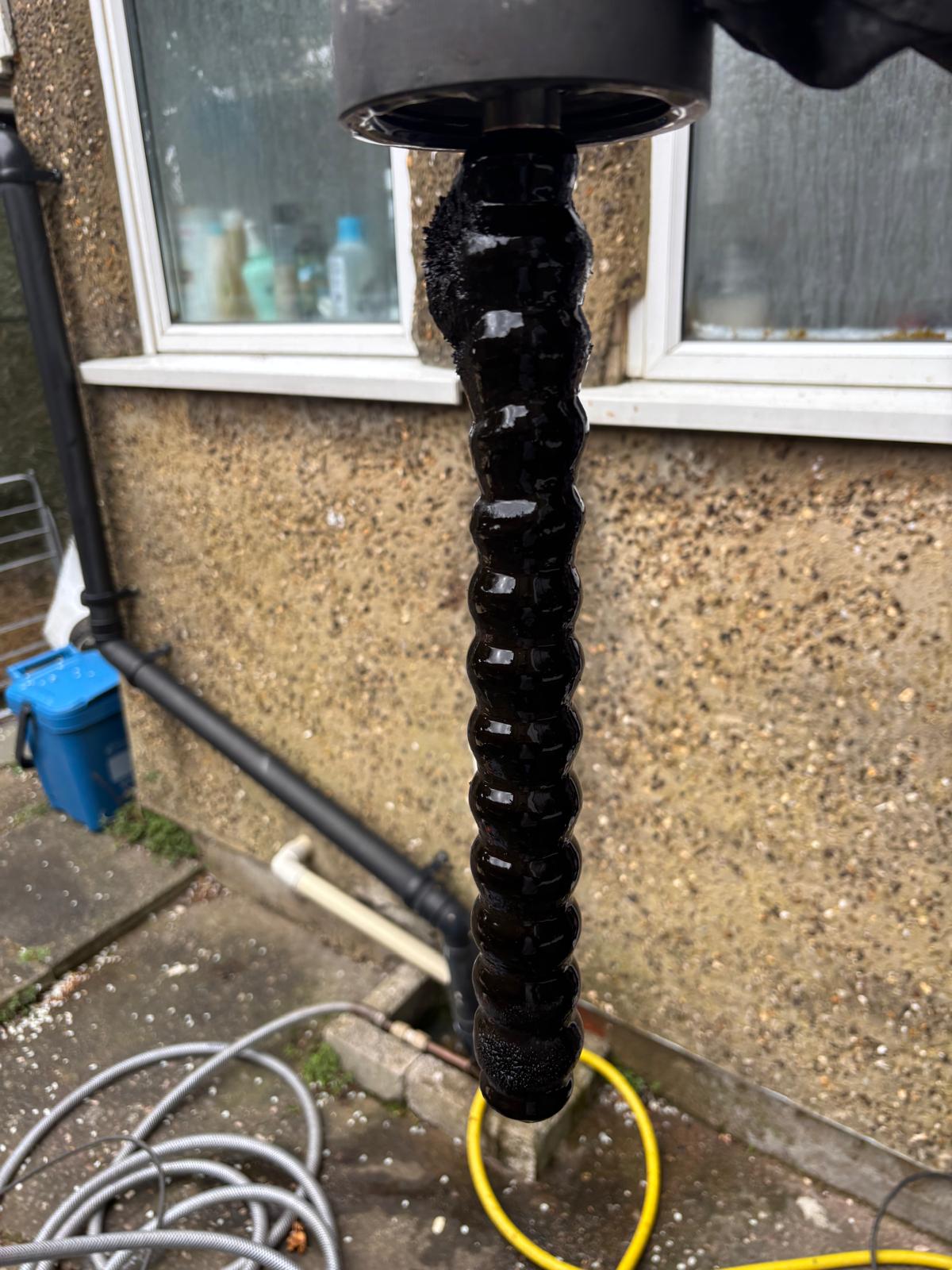 Thick black iron oxide sludge pulled from a central heating magnetic filter after a Kamco power flush
