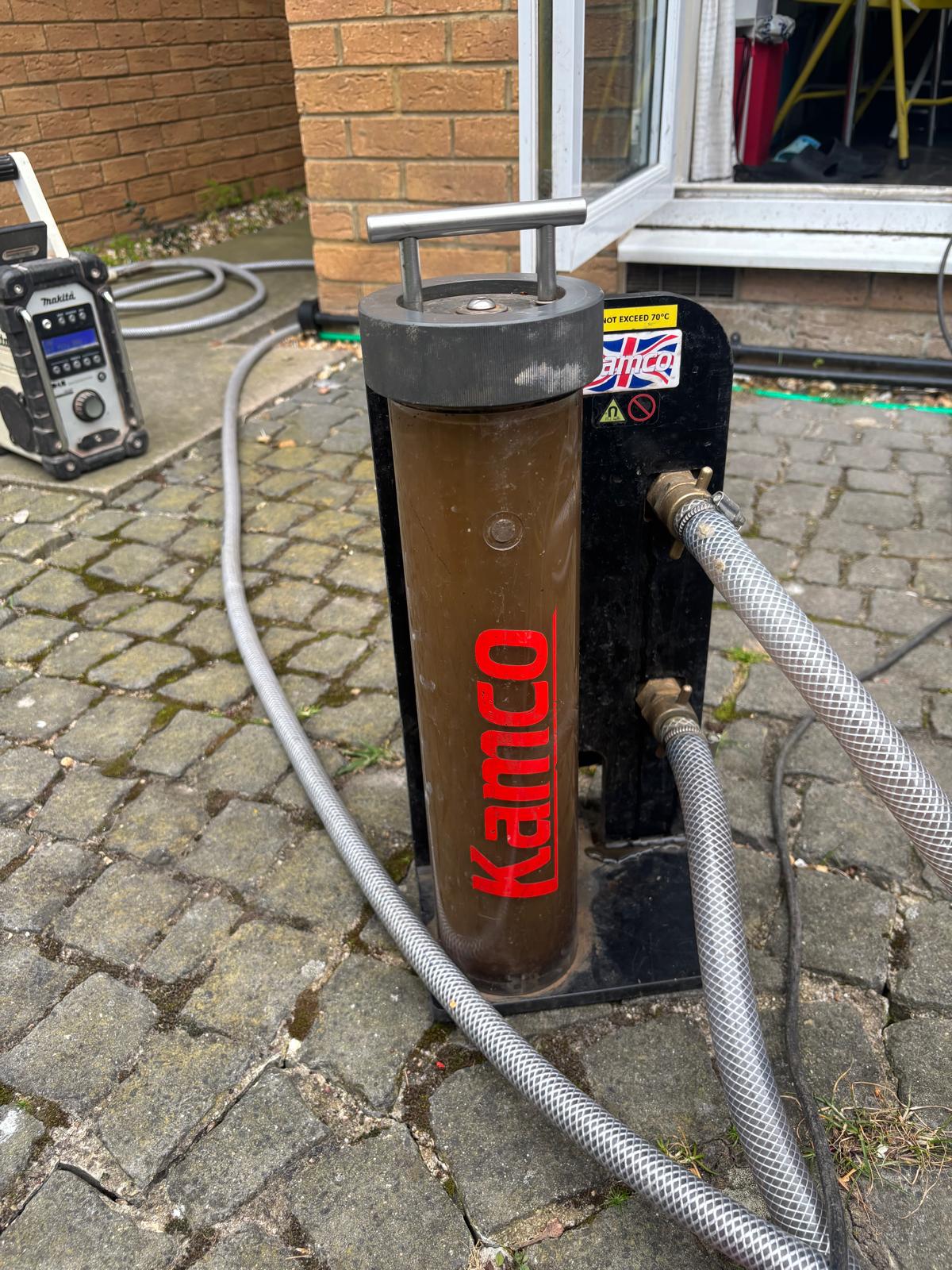 Kamco Clearflow power flush pump connected to the central heating manifold outside a customer's home